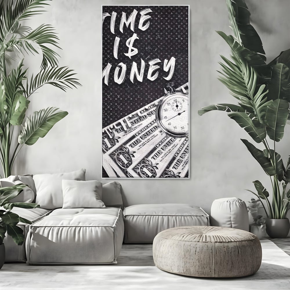 Tablou canvas cu tablou motivational cu bani si ceas, in rama de aluminiu argintiu, pe perete intr-un living